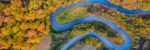 aerial-view-of-a-curved-road-winding-through-an-au-2024-03-08-00-34-12-utc