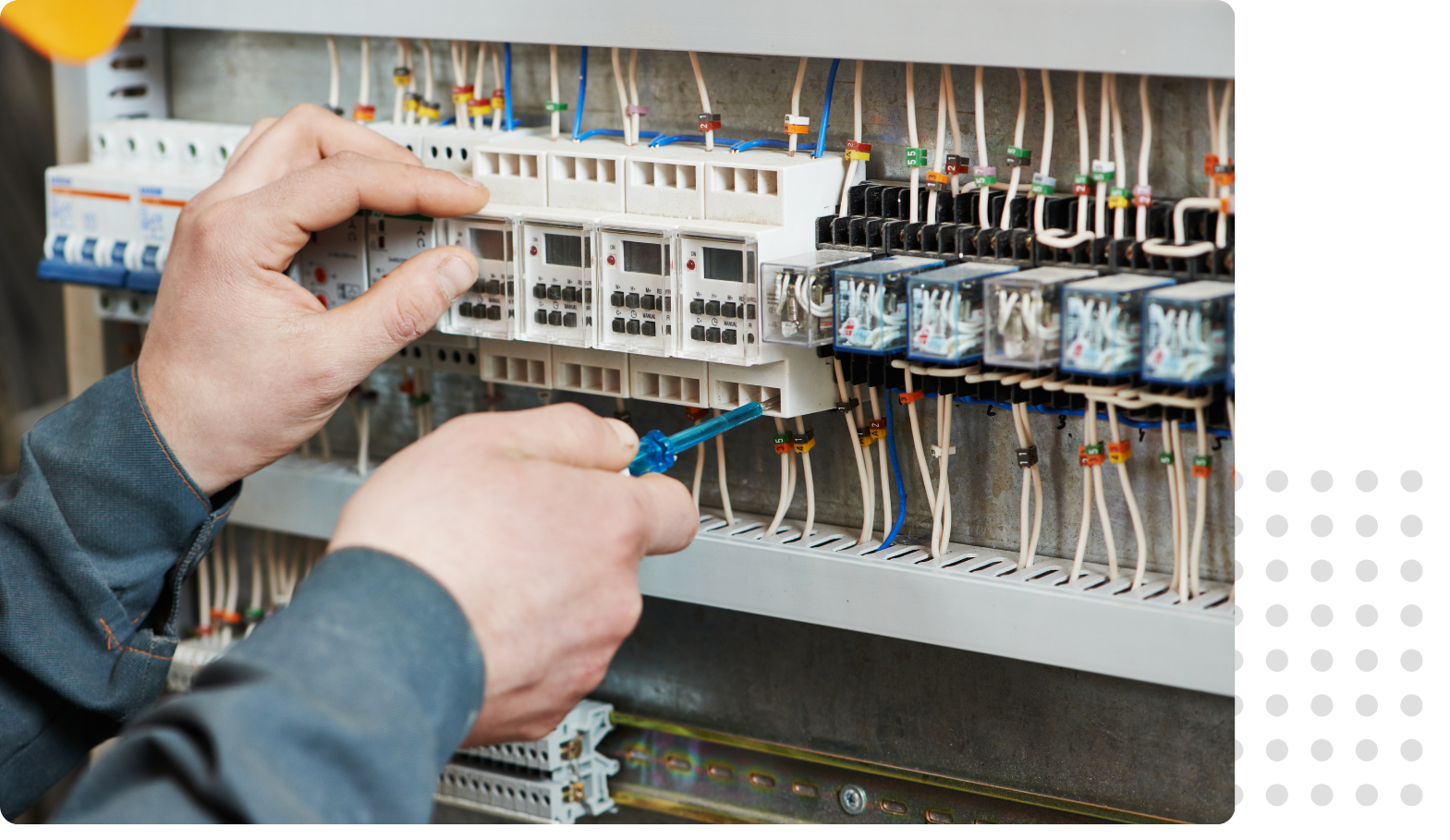 close up of hands working in a fuse box