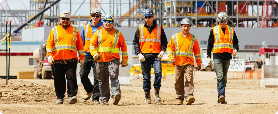 construction workers walking forward on a construction site